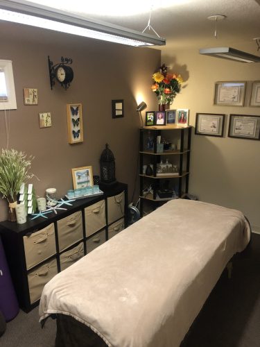 Serene therapy space with massage table and nature-themed décor at Spine & Injury Center of Grand Junction