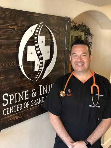 Clinic Director Dr. Christopher Angello, D.C., outside Spine & Injury Center of Grand Junction